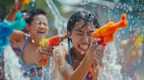 People with water gun wearing summer shirt in Songkran water festival © Nataliya