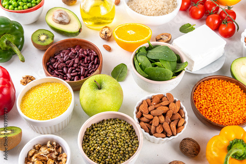 Portfolio Diet, balanced lowering cholesterol vegan food, including nuts, vegetable protein, plant sterols, viscous fiber, beans, legumes, fresh vegetables and fruits on white background copy space