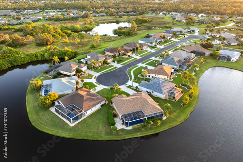 Low-density private homes at sunset. Rural street cul-de-sac dead end in residential suburbs with upscale suburban houses outside of Sarasota, Florida