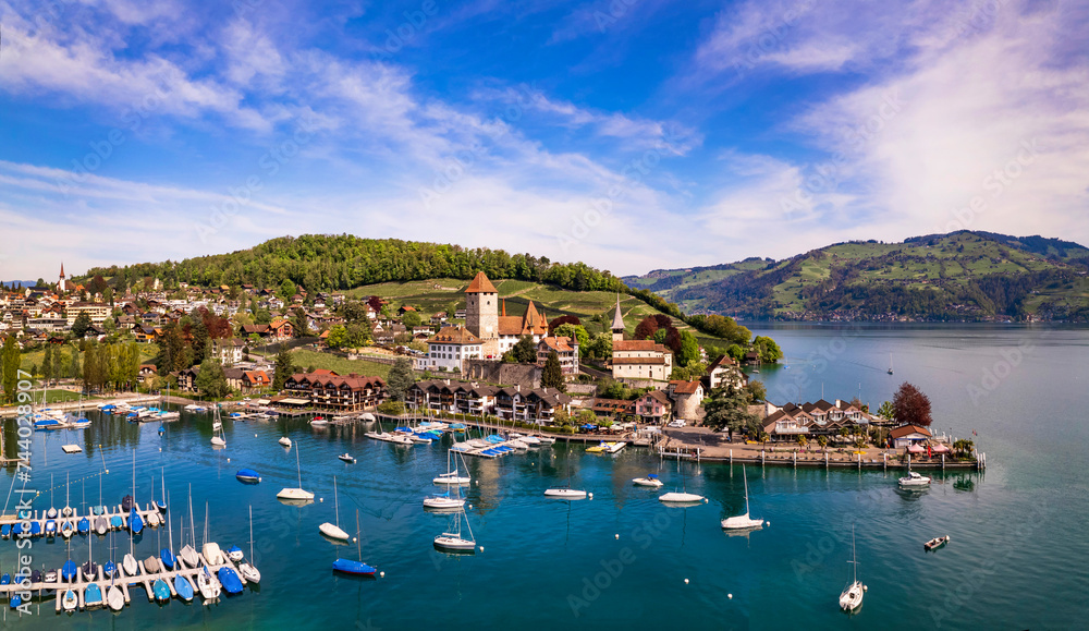 Canton Bern in Switzerland. aerial drone panorama of lake Thun and the Spiez village with medieval castle and old town