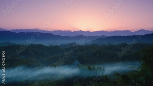 In the early morning, the sun rises from behind the mountains. The Erliao tribe in Zuozhen enjoys the sunrise landscape, Tainan City, Taiwan. photo