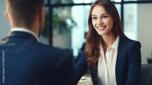 Young female professional smiling confidently during a job interview, showcasing her enthusiasm and communication skills