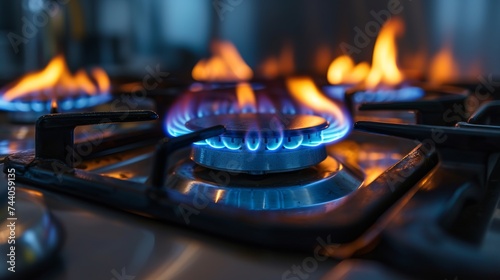 An industrial resource and economics notion is shown in this close-up of a blue fire blazing on the stovetop of a residential kitchen gas burner.
