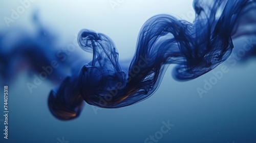  a close up of a blue substance floating in the air with a blurry back drop of water on the bottom of the image and the bottom of the image.