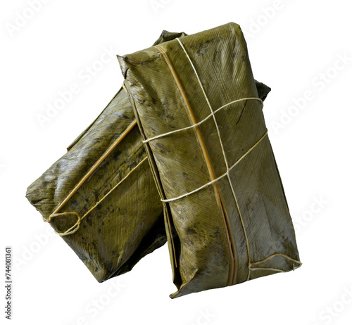 Colombian tamales in banana leaf on white background.