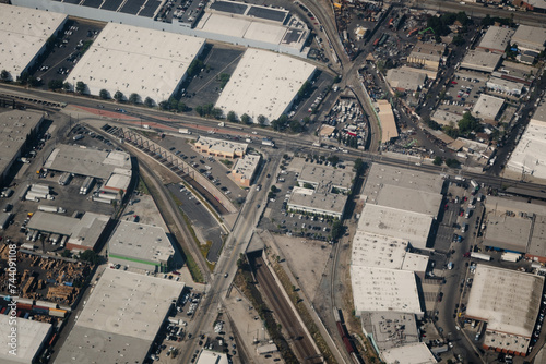 An aerial photo of the Alameda Corridor, an expressway for trains moving through Vernon, Los Angeles, and other areas in the broader LA area. The train track runs through a trench without car traffic.