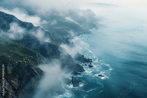 Aerial View of Rocky Coastline Along a Vast Body of Water, Overhead view of misty sea and jagged coastlines, AI Generated