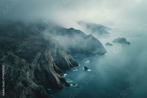 A large body of water peacefully nestled among majestic mountains, creating a breathtaking scene of natural beauty, Overhead view of misty sea and jagged coastlines, AI Generated