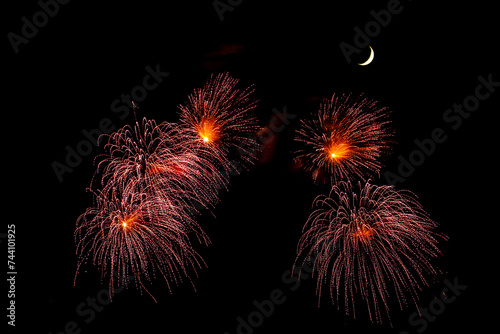 Montreal  Canada - June 25 2022  Fire works show with quarter moon in background at La Ronde in Montreal