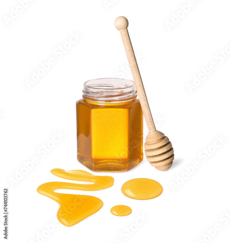 Natural honey in jar and wooden dipper on white background