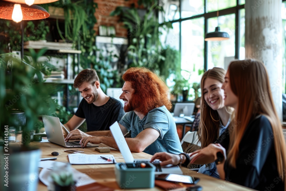 A diverse group of individuals sitting at a table, actively working on their laptops, Creative team working together on a laptop in an open-concept office, AI Generated A diverse group of individuals sitting at a table, actively working on their laptops, Creative team working together on a laptop in an open-concept office, AI Generated
