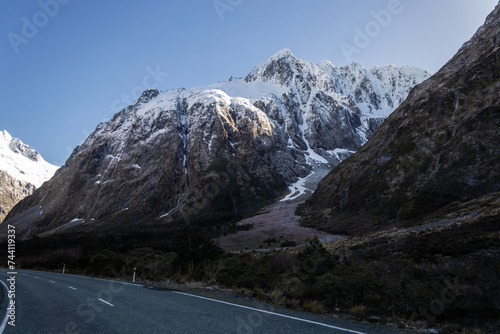road to mild ford sound with snowy mountain in the background
