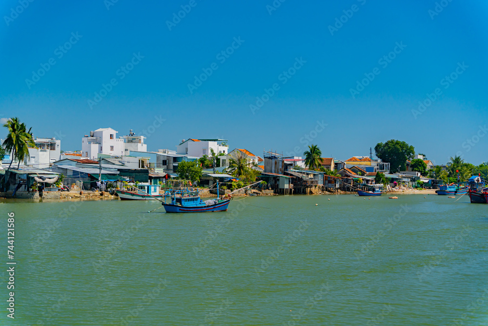 Fishing boats on the river.
The Kai River in Nha Trang in Vietnam. The urban landscape.