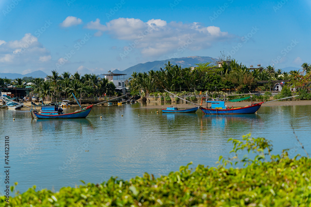Fishing boats on the river.
The Kai River in Nha Trang in Vietnam. The urban landscape.