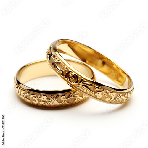 Traditional Gold Wedding Rings with Ornate Floral Design Isolated on White
