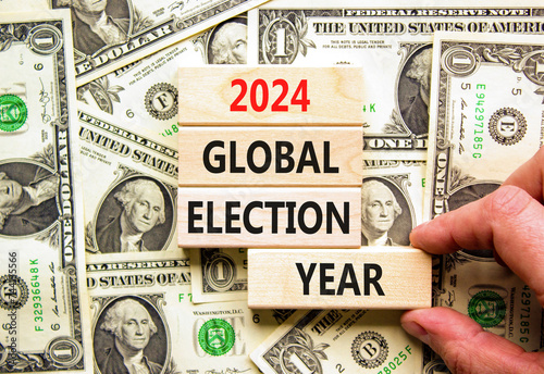 2024 global election year symbol. Concept words 2024 global election year on beautiful block. Beautiful dollar bills background. Voter hand. Business 2024 global election year concept. Copy space