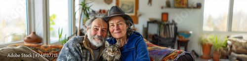 Senior couple embracing with cat at cozy home