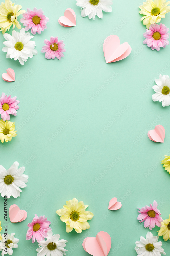 Petal symphony: spring's vibrant chorus. Top view vertical shot of white and pink flowers, heart-shaped paper decorations on teal background with space for messages