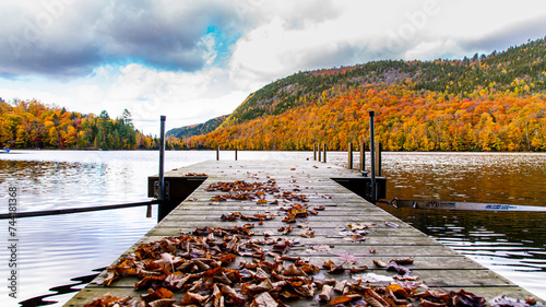 Lac-du-missionaire, Canada: Oct.10 2022: Morning fog on the lake of Lac-du-missionaire with colorful leaves in Quebec in a sunny autumn day