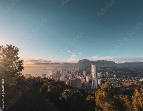 As the sun bids adieu, Benidorm unveils its majestic skyline from the heights of the sierra, painting a breathtaking tapestry of colors across the evening sky.