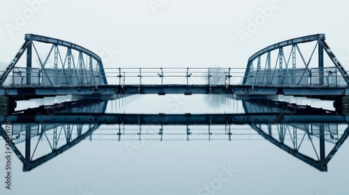 Two bridges, one spanning over the other, reaching towards the sky in a reflection of strength and connection over a flowing river