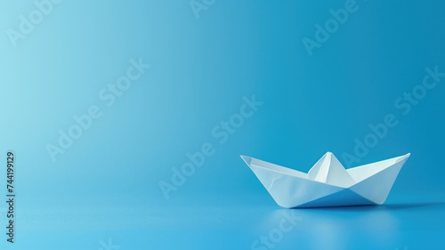 Paper boat on a blue surface