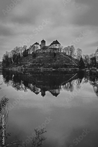 Landscape with a castle on the hill and a lake in front of it