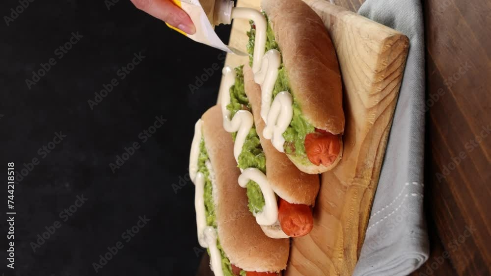 Chilean Typical Completo Food Hoy dog with tomato, avocado palta and mayonnaise Selective Focus. Vertical video.