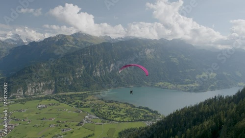 Paraglider flying over beautiful Switzerland valley - drone shot