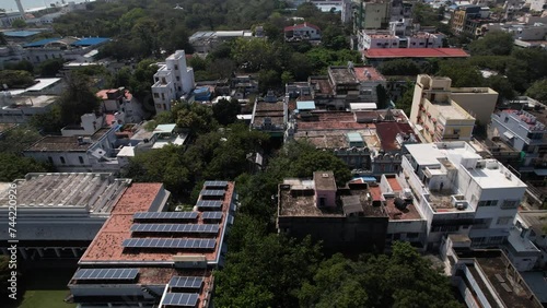 An aerial view of the Pondicherry-based spiritual community, Sri Aurobindo Ashram and Anakula Vinayagar Temple. The adjacent beach and city residence both have solar panels. photo