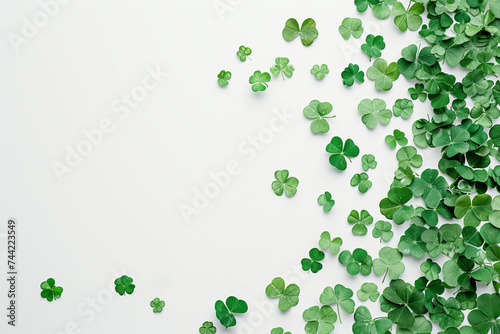 Green clover leaves scattered on a white background, space for copy, Saint Patrick's Day theme, luck concept