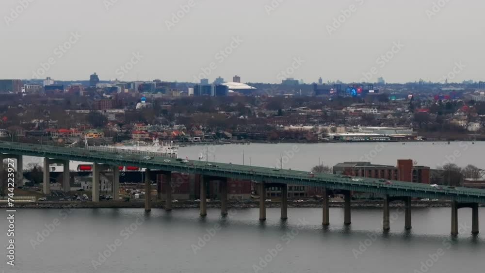 An aerial view of the Throgs Neck Bridge elevated roadway from over the Long Island Sound, NY on a cloudy day. The camera truck left and pan right. An aerial view of the Throgs Neck Bridge elevated roadway from over the Long Island Sound, NY on a cloudy day. The camera truck left and pan right.