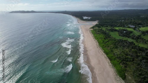 Idyllic Ocean And Lush Vegetation At Belongil Beach In Byron Bay, NSW, Australia - Aerial Shot photo