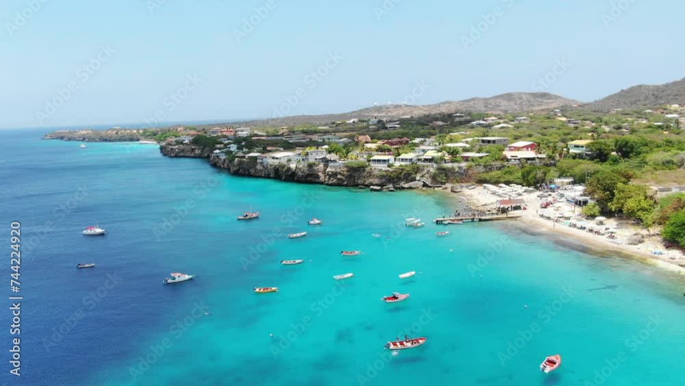 Playa piskado in curacao, turquoise waters with boats and coastal village, aerial view Playa piskado in curacao, turquoise waters with boats and coastal village, aerial view