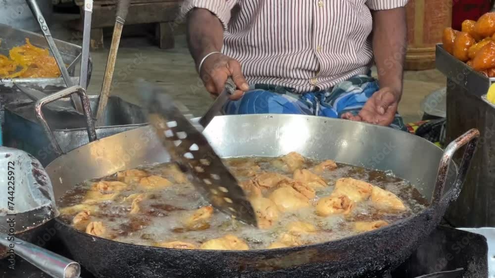 Close up of a man preparing hot samosa in a roadside hotel in Kolkata, India. No face. Close up of a man preparing hot samosa in a roadside hotel in Kolkata, India. No face.