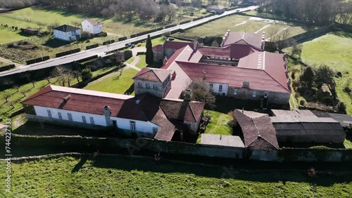 Drone left to right orbit around roof top establishing San Salvador de Ferreira monastery photo