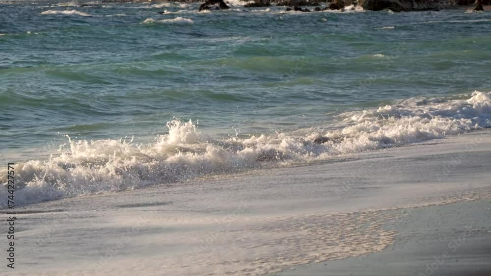 Beautiful cinematic view of waves crashing at beach