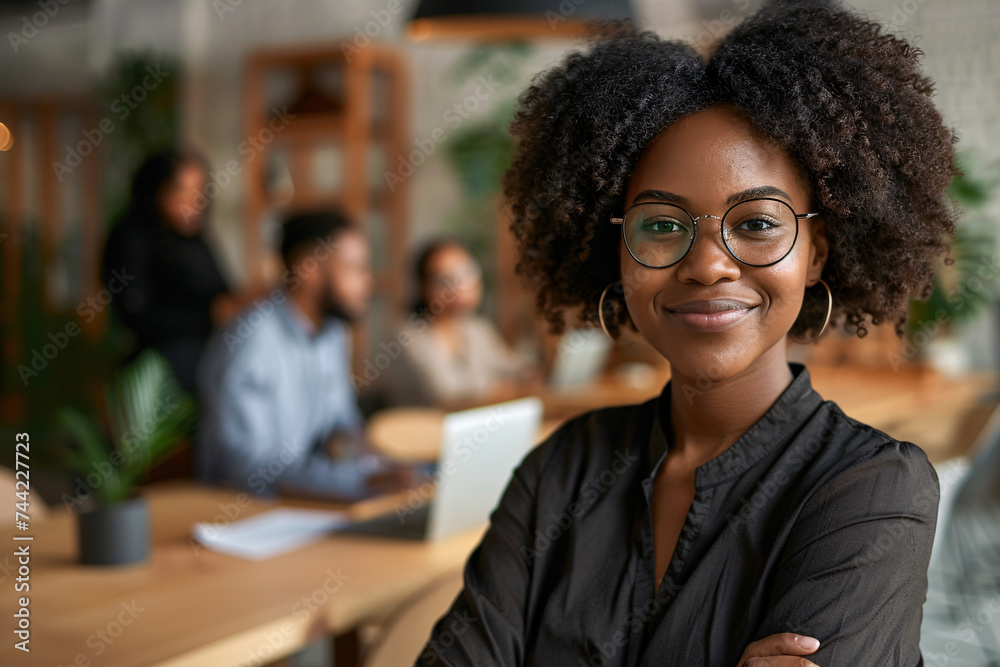 Smiling afro woman ceo with glasses, Happy business woman standing in office with arms crossed. Smiling afro woman ceo with glasses, Happy business woman standing in office with arms crossed.