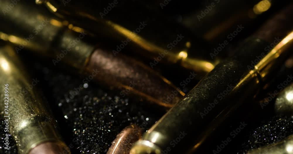 Macro detail closeup of 300 AAC Blackout bullets on gunpowder dust, circle pan Macro detail closeup of 300 AAC Blackout bullets on gunpowder dust, circle pan