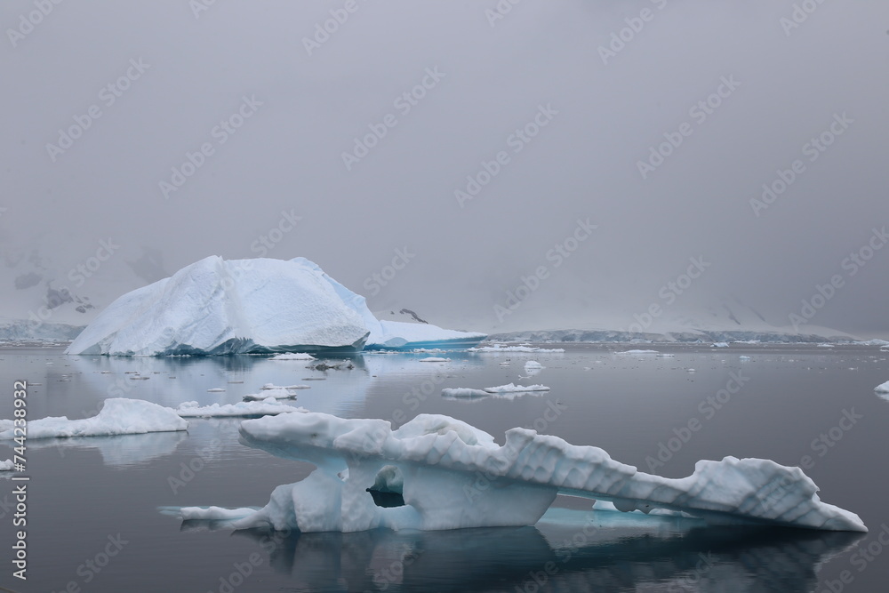 Icebergs in foggy ocean waters in Antarctica