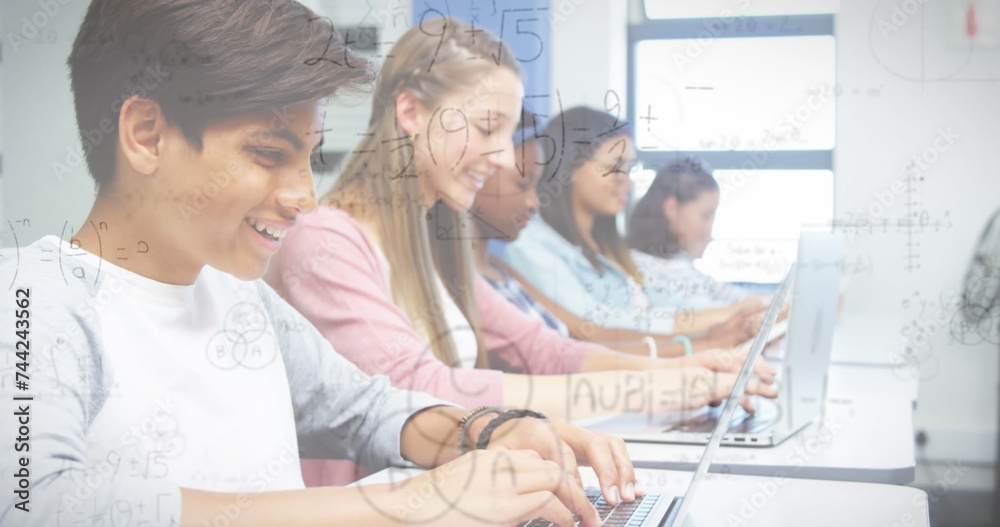 Image of mathematical formulas over students using computers Image of mathematical formulas over students using computers