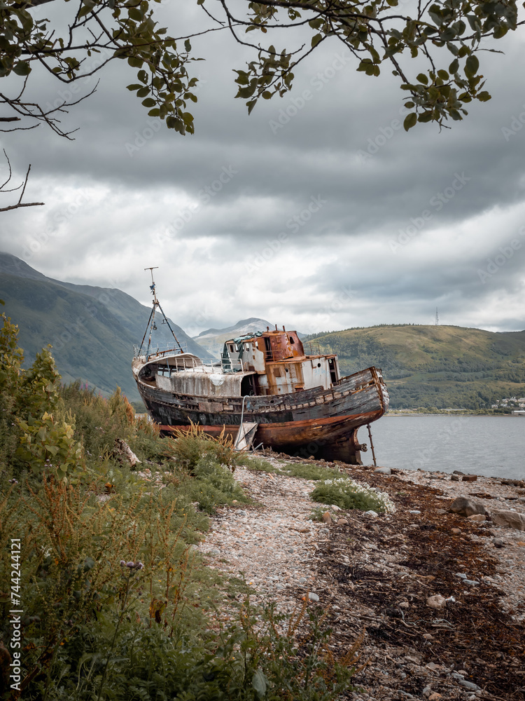 Shipwreck on the beach at Coal overlooked by Scotlands highest mountain Ben Nevis.