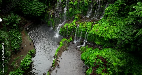 Banyu Wana Amertha waterfall and natural pool, Bali in Indonesia. Aerial top-down descending photo