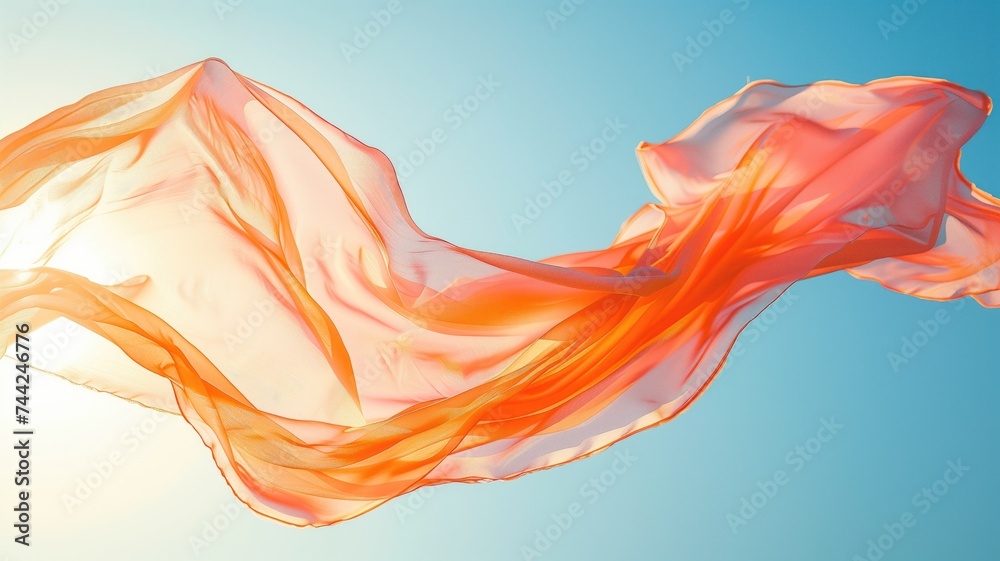 Vibrant orange fabric billowing against a clear blue sky Vibrant orange fabric billowing against a clear blue sky
