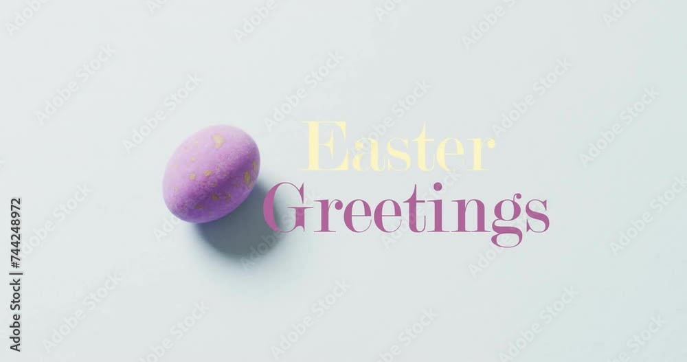 Animation of happy greetings text over purple easter egg on bue background Animation of happy greetings text over purple easter egg on bue background