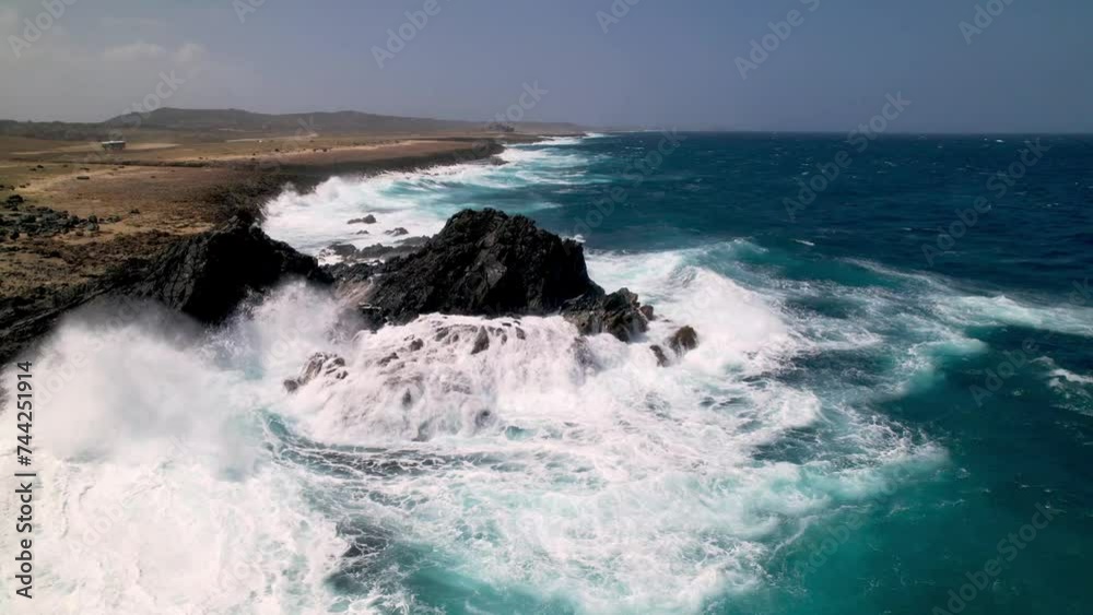 powerful waves crash against rock formation in aruba powerful waves crash against rock formation in aruba