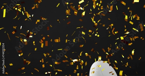 Animation of confetti over white rugby ball on black background photo