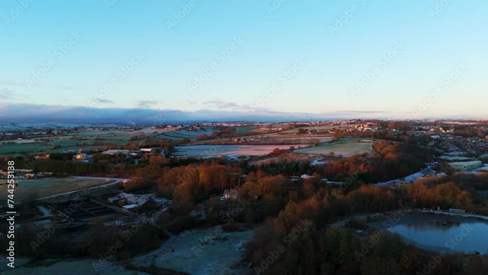 Daybreak on a very cold winters morning in Yorkshire, UK. Middle-class suburban houses in English market town village. Winter, snow, cold, freezing weather.
