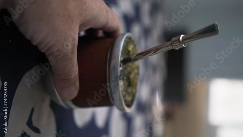 Pouring hot water onto a mate, traditional Argentinian beverage photo