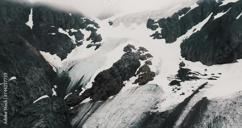 Snowy Rocky Mountains Of Glaciar Vinciguerra In Ushuaia, Tierra del Fuego Province, Argentina. Aerial Drone Shot photo
